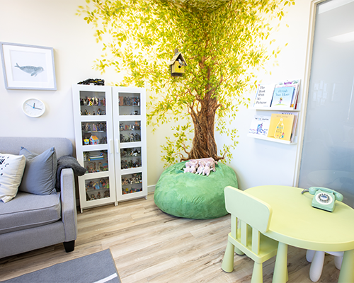 A painted tree mural in a playroom at Kids Reconnect.
