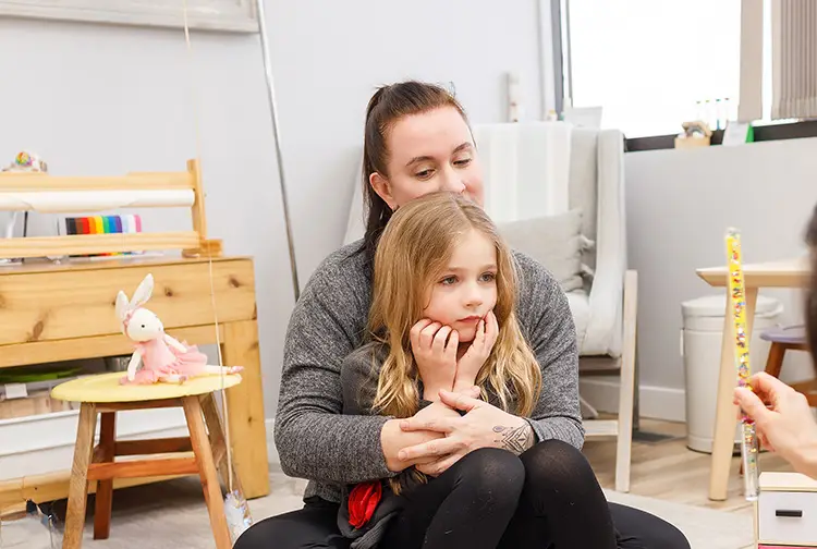 A mother hugs her child curing an EMDR therapy session at Kids Reconnect