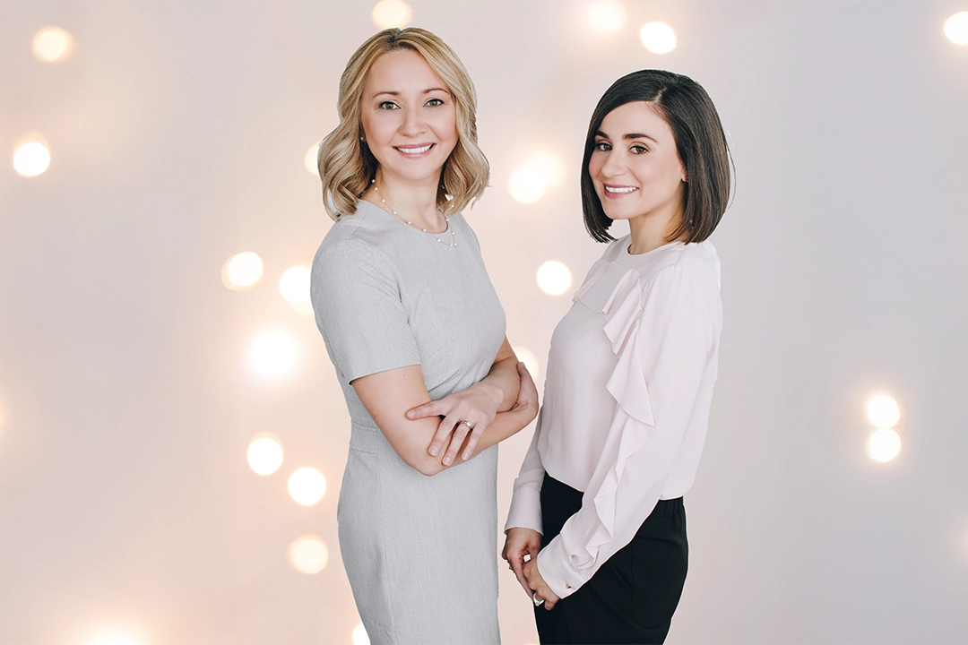 Natalie Bergman and Marcella Galizia, Registered Psychologists. Holiday lights in the background