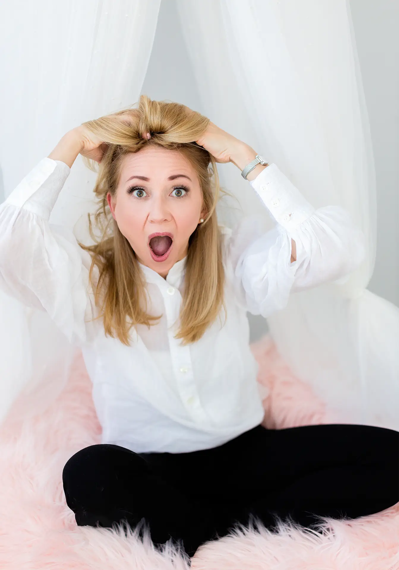 Natalie Bergman, child psychologist shows what tricky feelings might look like A child psychologist sitting on a fluffy pink pouff pillow, making a "tricky feelings" "acting out" expression as she pretends to pulls on her hair.